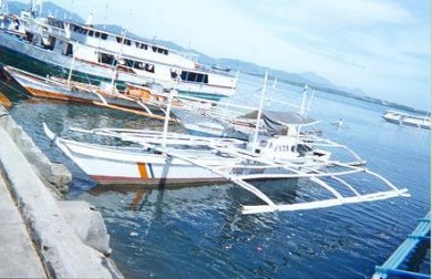 Philippino Coast Guard boat with bamboo outriggers.